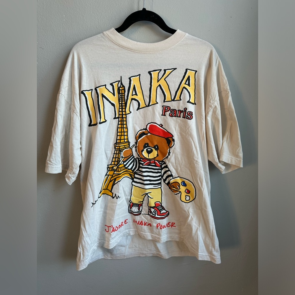 Inaka Power White Graphic Tee with Yellow, Red, Black Accents